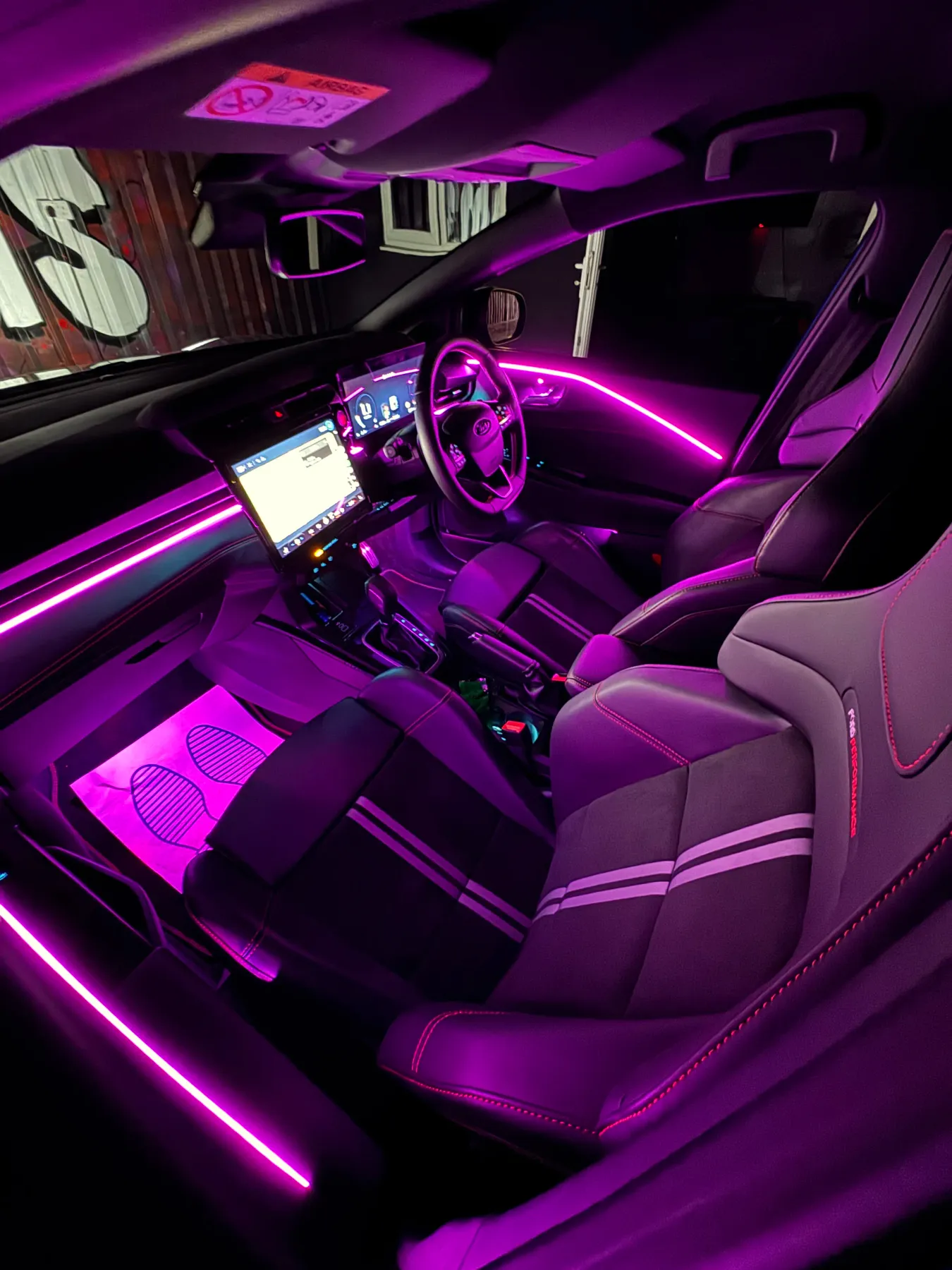 Ford Focus interior with purple ambient lighting and lit footwells.